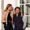 couple in beige woman jacket and navy vest